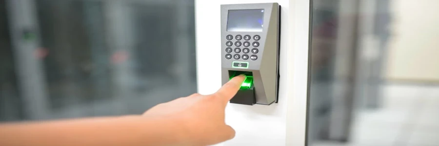 A person uses a fingerprint scanner for secure entry