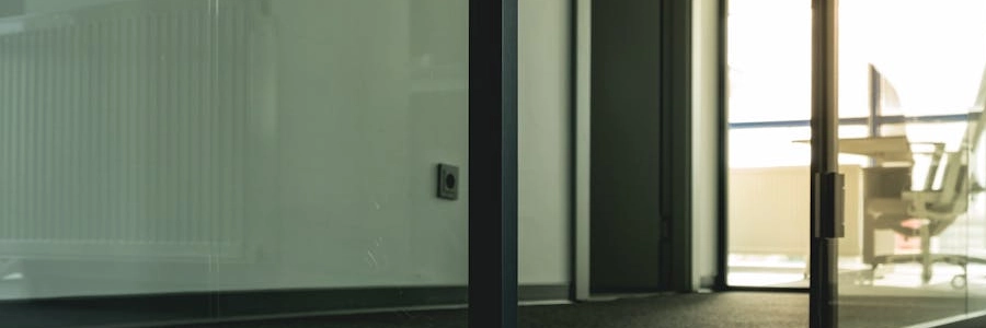 Contemporary office space with glass doors and minimalist design elements