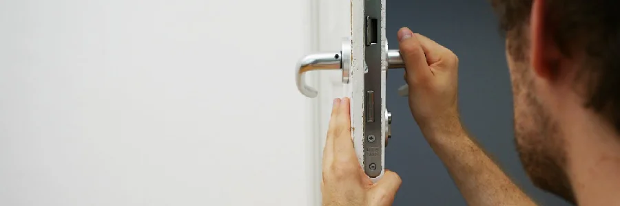 Man assessing a door lock