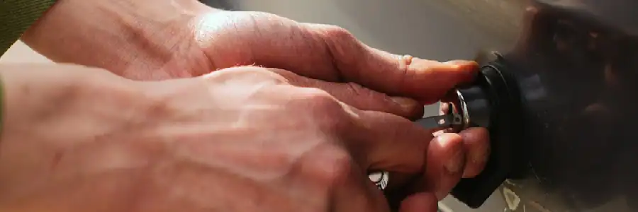 hands of a person trying to open a locked car door