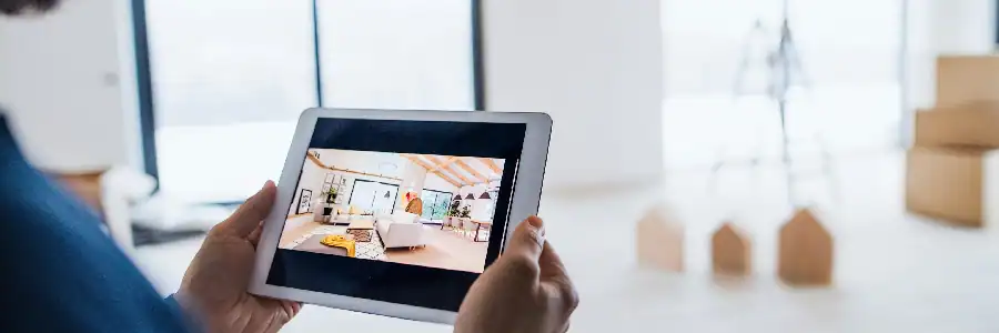 man watching live feed of his living room through an indoor camera
