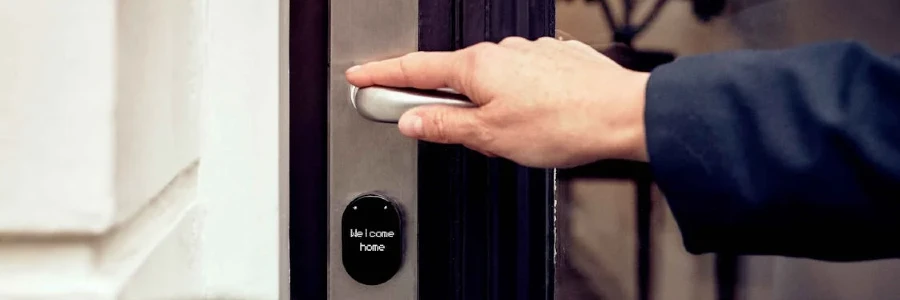 A hand opening a smart home door