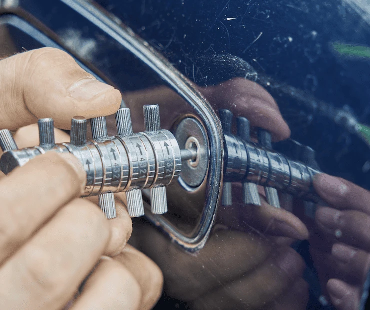 Locksmith using a lock picker to unlock a car door